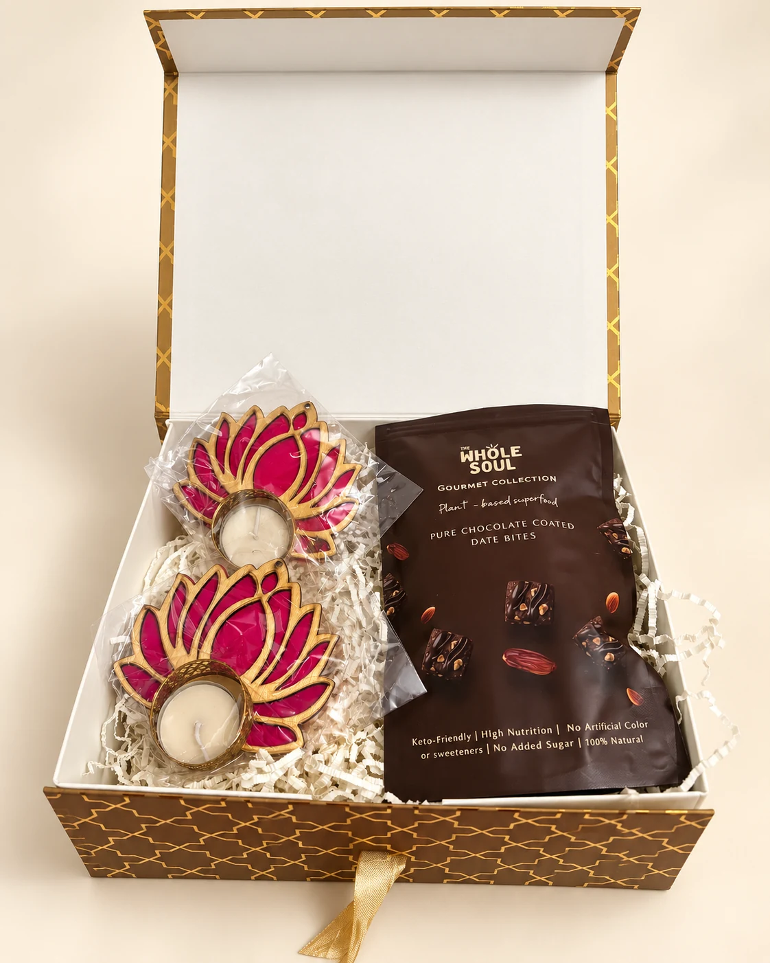Gold patterned gift box with lotus diyas and chocolate-coated date bites