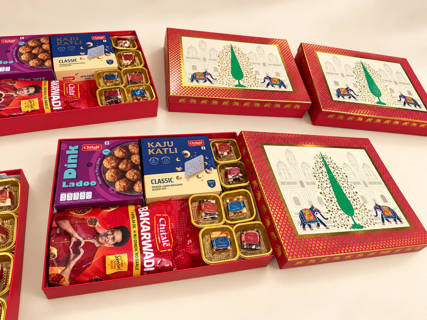 Several red gift boxes with Maharashtrian snacks, sweets and chocolates