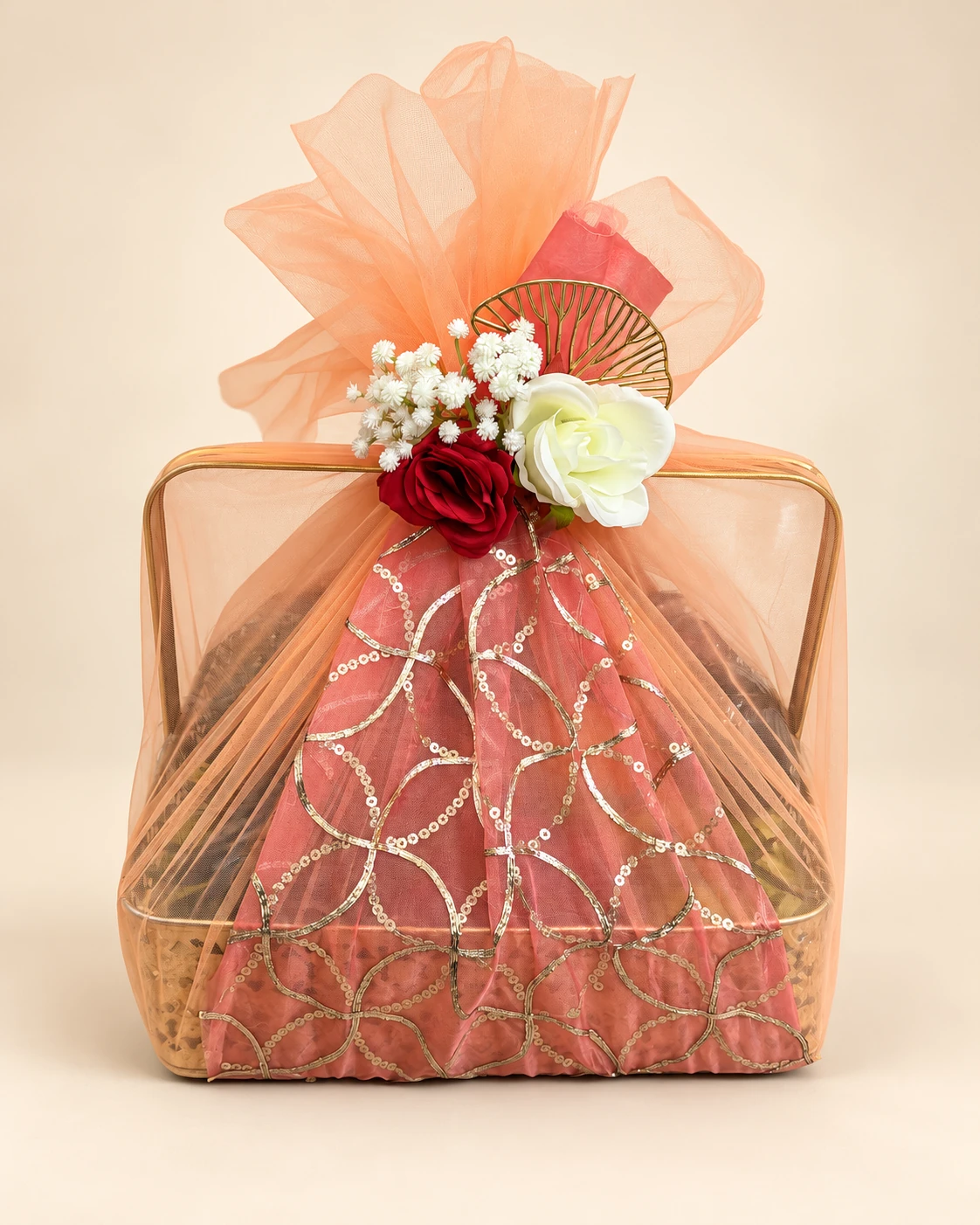 Basket wrapped in peach net with red and white roses