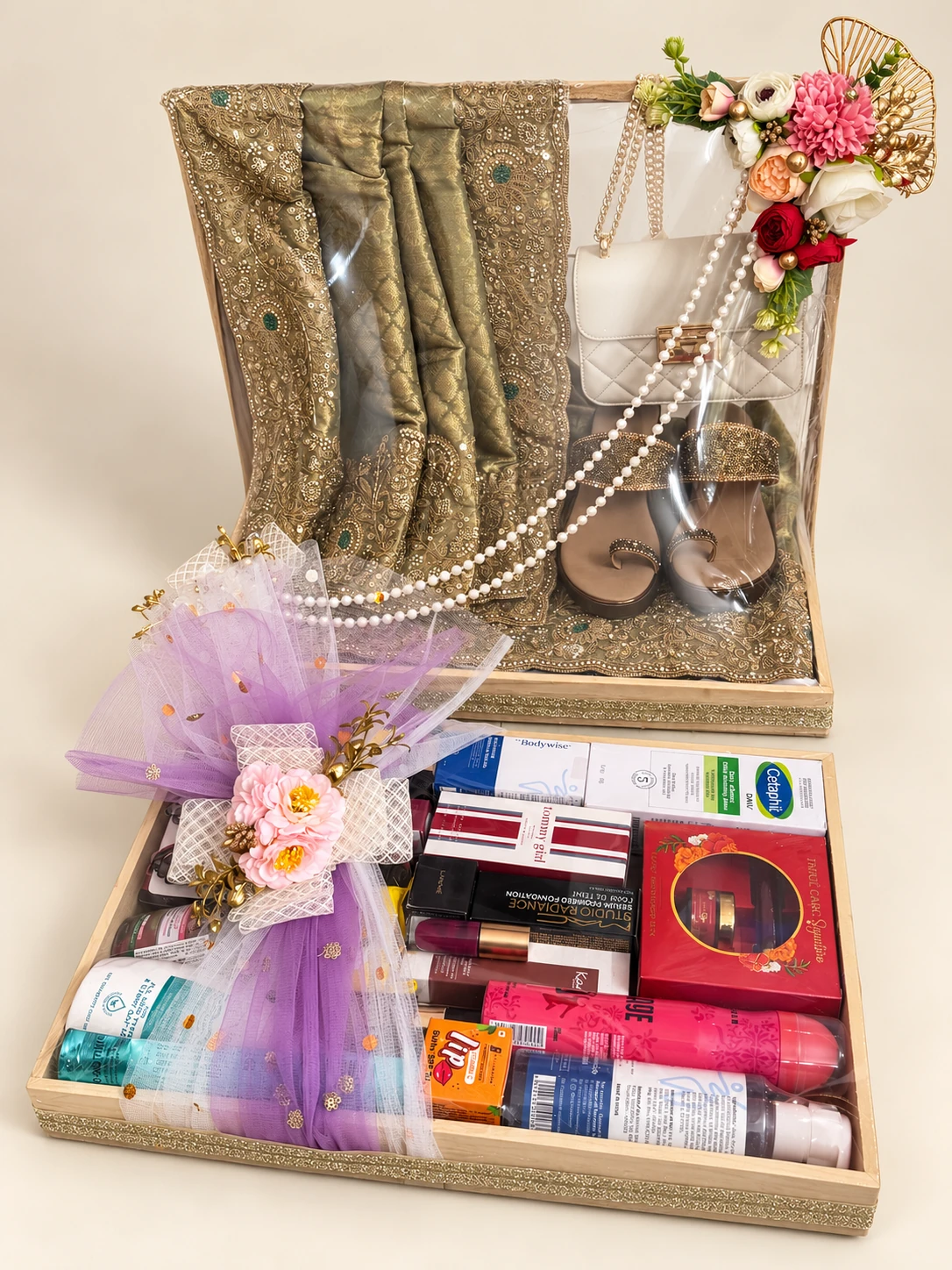 Framed outfit and footwear display above a tray of cosmetics finished with lilac net