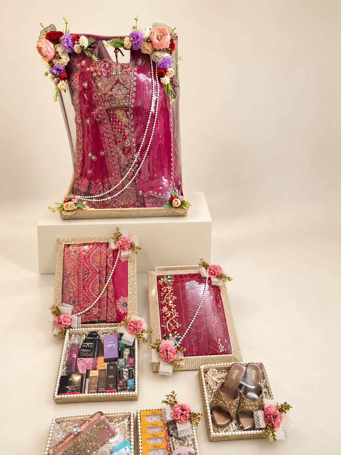 Bridal trousseau set: a framed saree display with matching trays of cosmetics, accessories and footwear