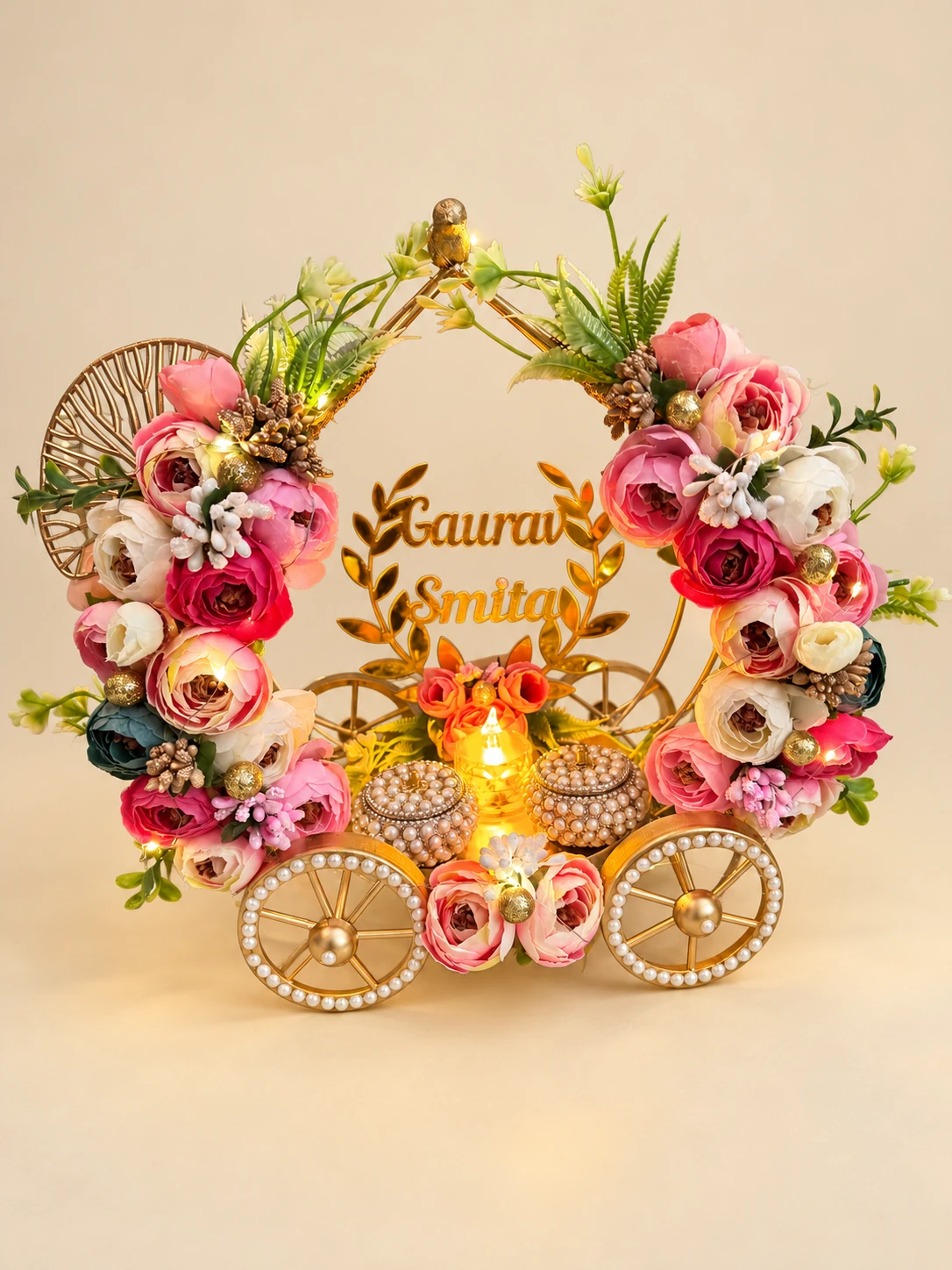 Floral carriage-shaped ring display with fairy lights and two ring boxes
