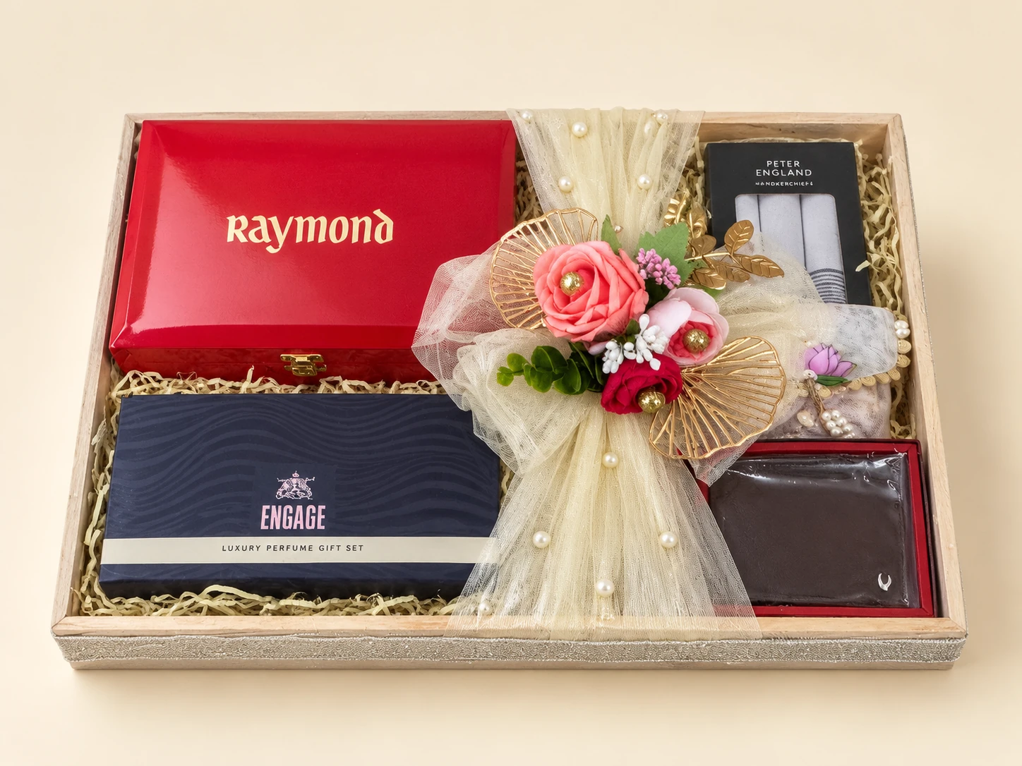 Gift tray with a red box, a belt, handkerchiefs and a cream net bow with roses